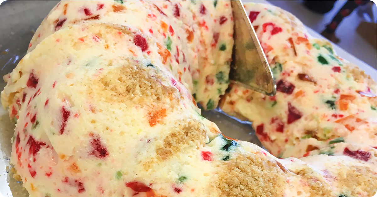 A multicolor Jello salad made in a bundt cake pan.